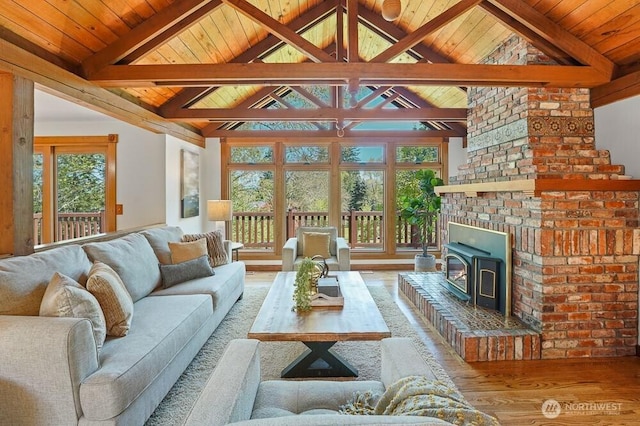 living area featuring wooden ceiling, lofted ceiling with beams, a wood stove, and wood finished floors