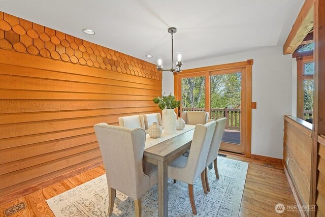dining space featuring an inviting chandelier, baseboards, recessed lighting, and light wood-style flooring