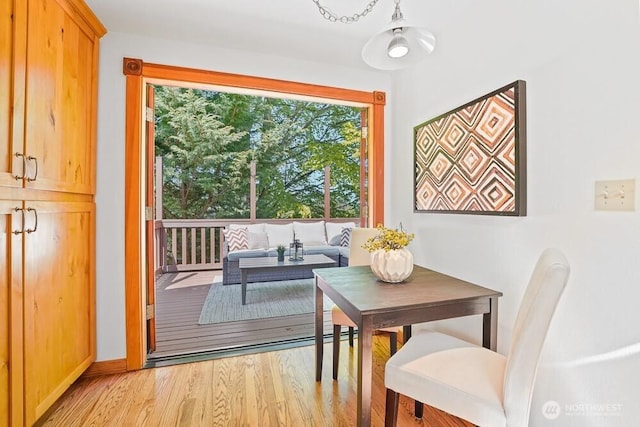 dining space featuring baseboards and light wood-style floors