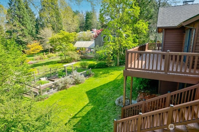 view of yard with a wooden deck and a garden