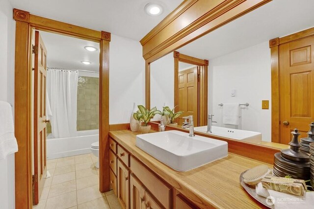 full bath featuring shower / bath combo, tile patterned flooring, vanity, toilet, and recessed lighting