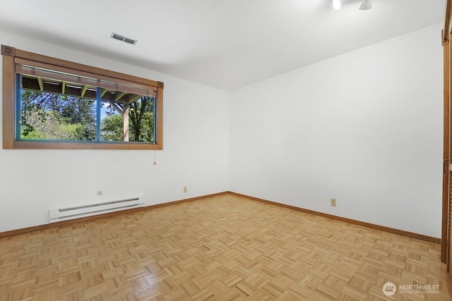 unfurnished room featuring baseboards, a baseboard heating unit, and visible vents