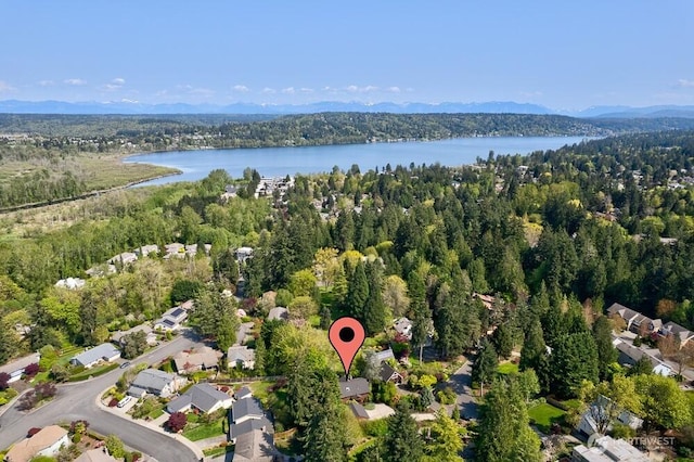 bird's eye view with a water view and a forest view