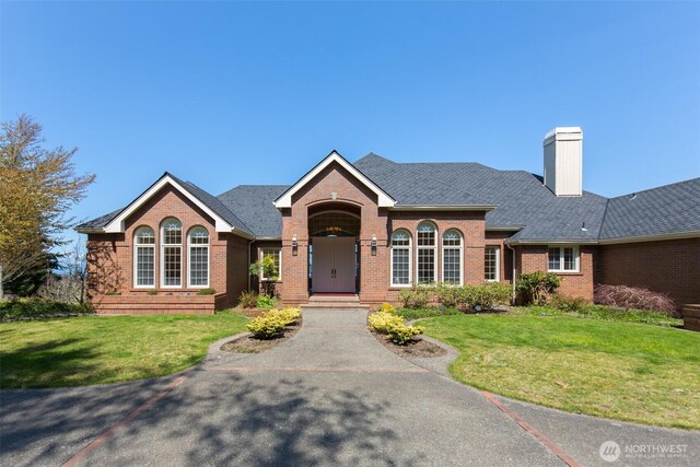 581 Harbor View Dr, Port Angeles, WA 98363 - ranch-style house featuring brick siding, a chimney, and a front yard