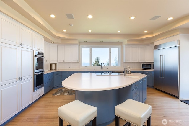 581 Harbor View Dr, Port Angeles, WA 98363 - kitchen featuring light countertops, appliances with stainless steel finishes, backsplash, and blue cabinets