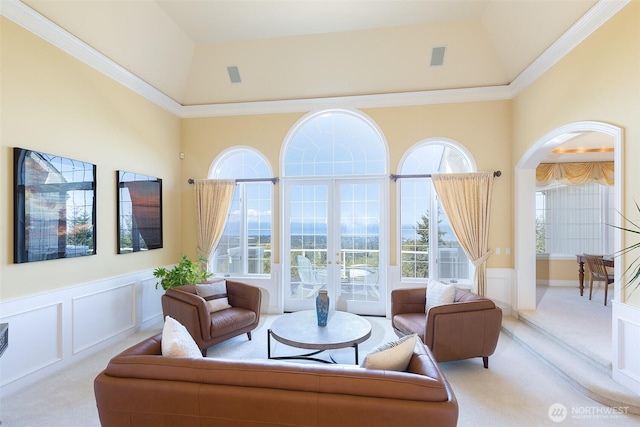 581 Harbor View Dr, Port Angeles, WA 98363 - living area with carpet flooring, wainscoting, arched walkways, and a decorative wall