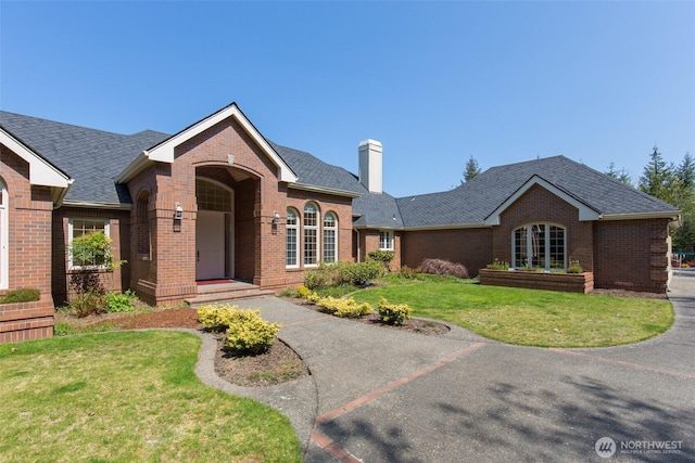 581 Harbor View Dr, Port Angeles, WA 98363 - ranch-style home featuring a chimney, a front yard, and brick siding