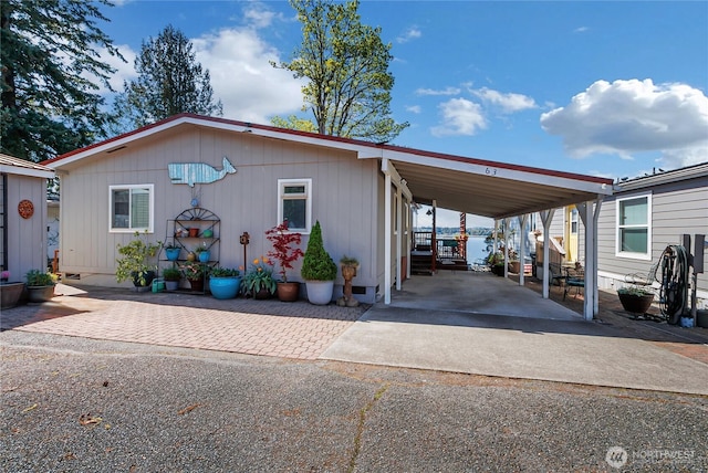 manufactured / mobile home featuring driveway and an attached carport