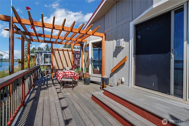 wooden terrace with a pergola and a water view