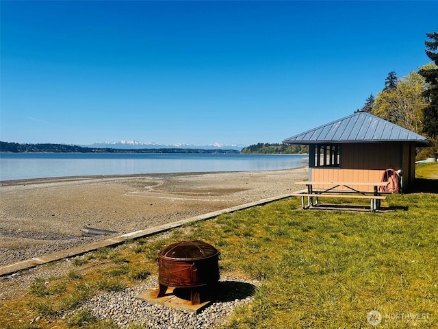 property view of water featuring an outdoor fire pit