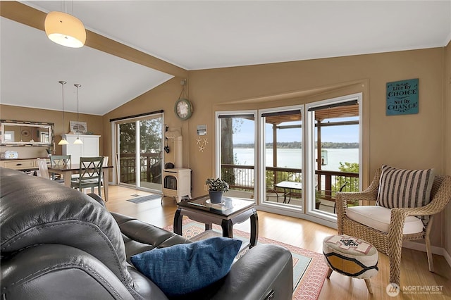 living area featuring light wood-style floors, a water view, and lofted ceiling