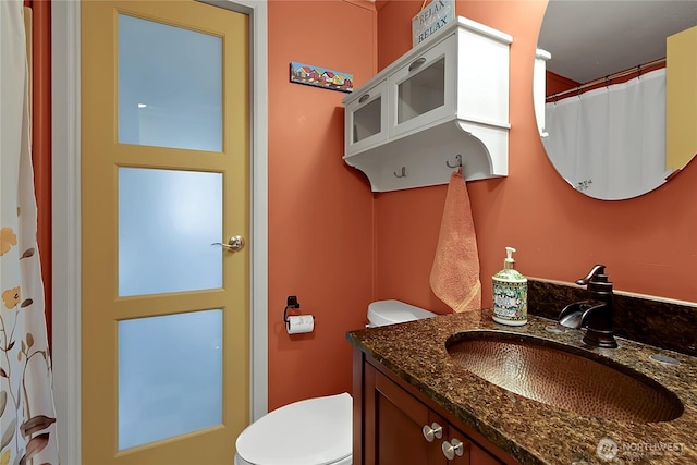 bathroom featuring toilet and vanity