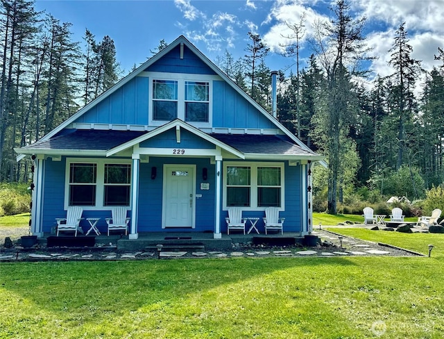 229 Westcott Dr, San Juan Island, WA 98250 - view of front facade with a front lawn, board and batten siding, a porch, and a shingled roof