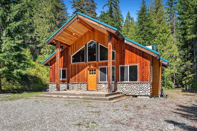 251 Kachess River Rd, Easton, WA 98925 - back of house with stone siding, a view of trees, and crawl space