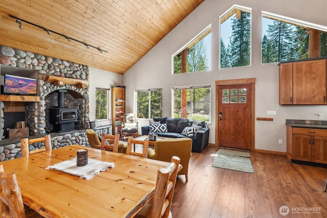 251 Kachess River Rd, Easton, WA 98925 - dining area featuring track lighting, a wood stove, high vaulted ceiling, hardwood / wood-style floors, and wood ceiling