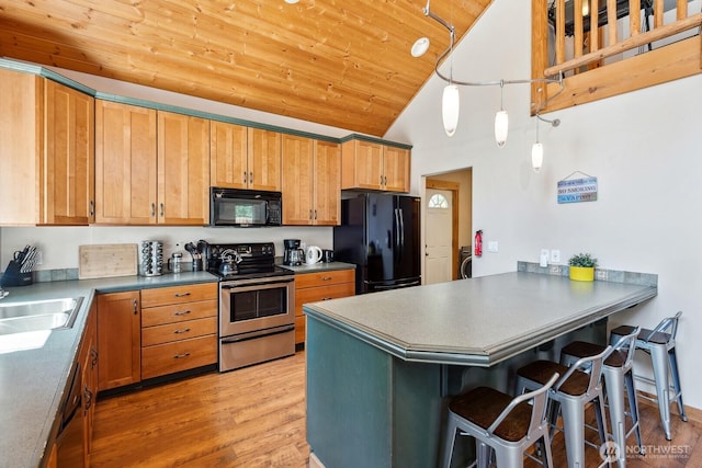 251 Kachess River Rd, Easton, WA 98925 - kitchen with black appliances, high vaulted ceiling, a peninsula, a sink, and wood ceiling