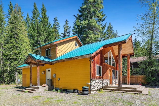 251 Kachess River Rd, Easton, WA 98925 - rear view of house featuring metal roof, board and batten siding, crawl space, and fence