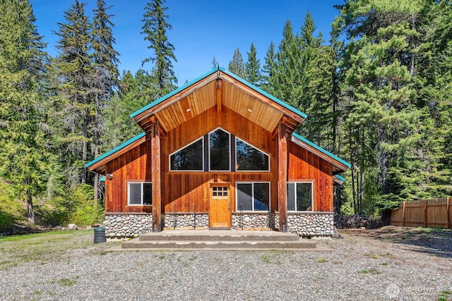 251 Kachess River Rd, Easton, WA 98925 - view of front of home with stone siding, fence, and a wooded view