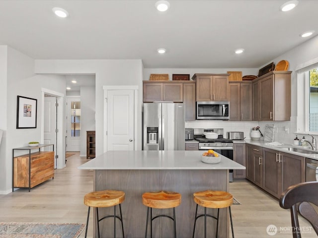 20352 132nd St SE, Monroe, WA 98272 - kitchen featuring a sink, light wood-style flooring, a kitchen island, and stainless steel appliances