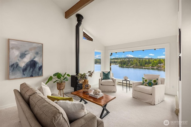 living room with a wood stove, beam ceiling, high vaulted ceiling, a water view, and carpet flooring