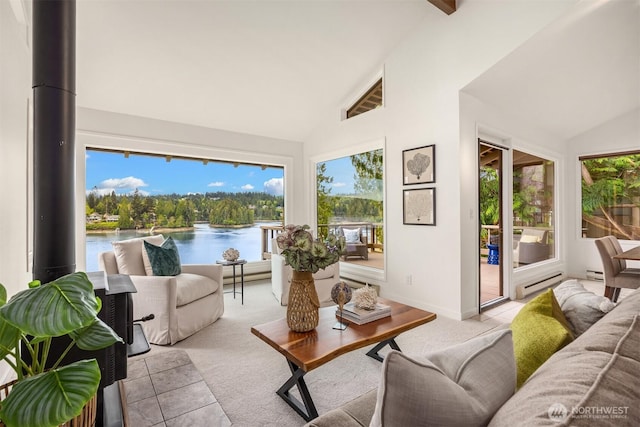 sunroom featuring baseboards, a baseboard radiator, a water view, and high vaulted ceiling