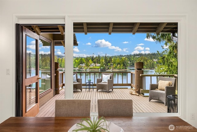 sunroom featuring a water view and wood finished floors