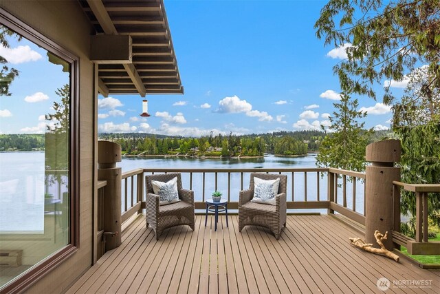 wooden terrace featuring a water view