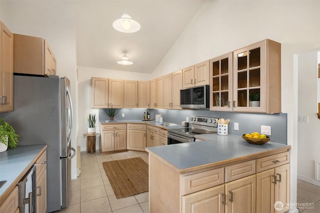 kitchen with light tile patterned floors, light brown cabinets, and stainless steel appliances