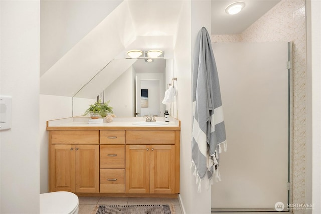 bathroom with vanity, a stall shower, tile patterned floors, and toilet