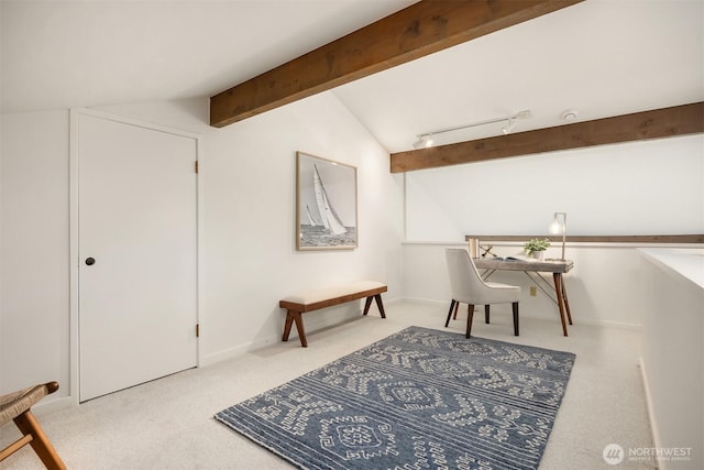 carpeted office space with track lighting and vaulted ceiling with beams