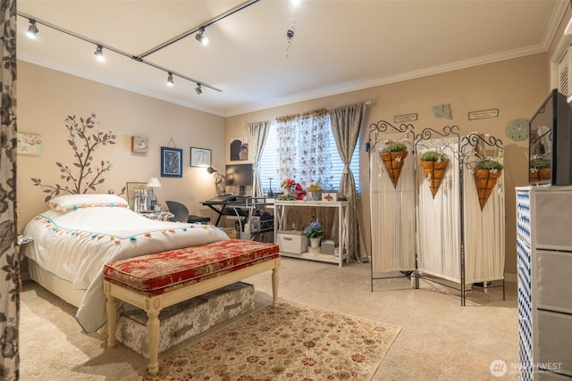 carpeted bedroom featuring track lighting and ornamental molding