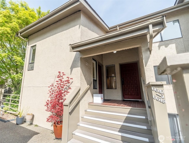 entrance to property featuring stucco siding