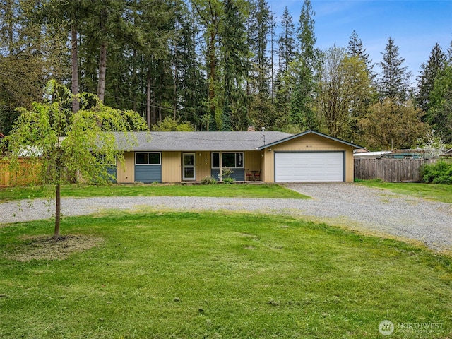 single story home featuring fence, a garage, a front yard, a chimney, and driveway