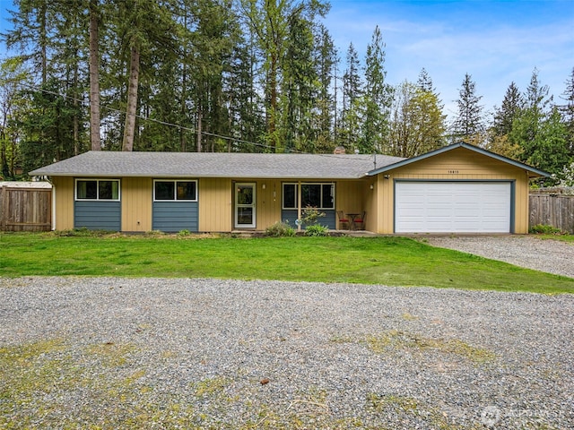 single story home featuring a garage, fence, a front yard, gravel driveway, and roof with shingles