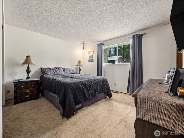 carpeted bedroom featuring visible vents and a textured ceiling