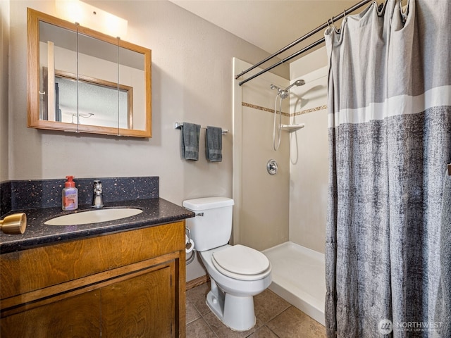 bathroom with vanity, tile patterned floors, toilet, and a shower with curtain