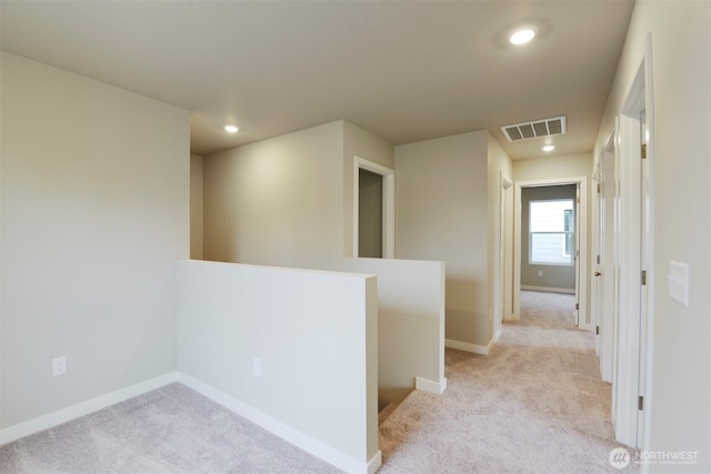 hall featuring recessed lighting, an upstairs landing, visible vents, baseboards, and light colored carpet
