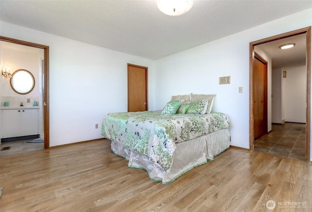 bedroom with wood finished floors and baseboards