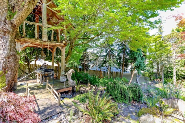 view of yard featuring fence and a wooden deck
