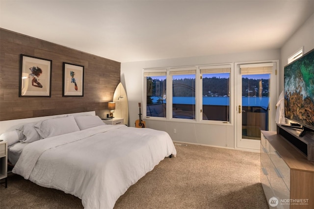 bedroom with wood walls and carpet