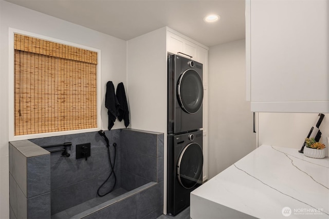 washroom with laundry area, stacked washer and clothes dryer, and recessed lighting