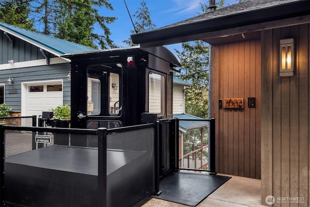 view of exterior entry with metal roof and board and batten siding