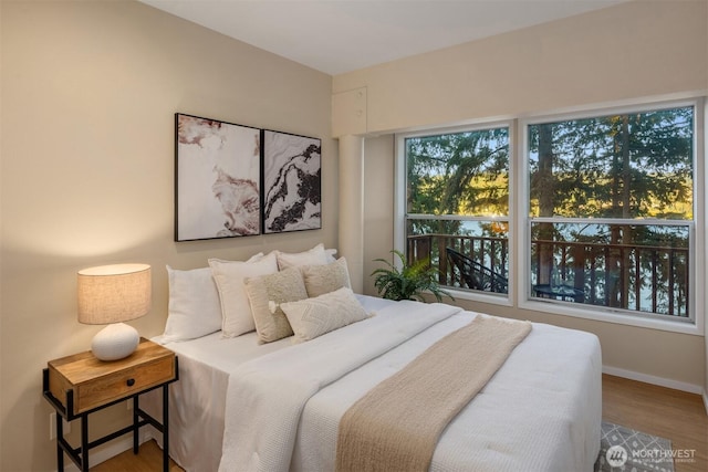 bedroom featuring baseboards and wood finished floors
