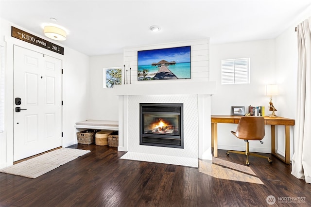 foyer entrance with visible vents, wood finished floors, and a healthy amount of sunlight