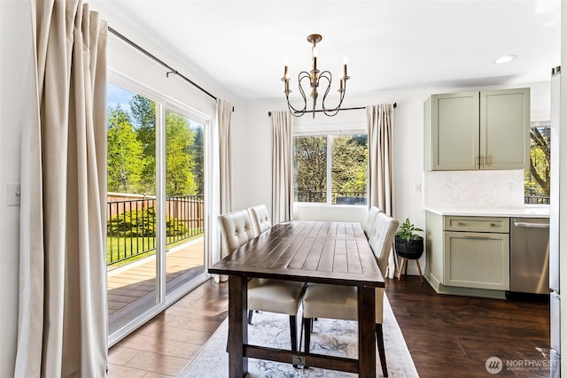 dining room with recessed lighting, a notable chandelier, and dark wood-type flooring
