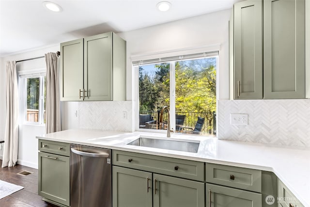 kitchen with a sink, dishwasher, a wealth of natural light, and light countertops