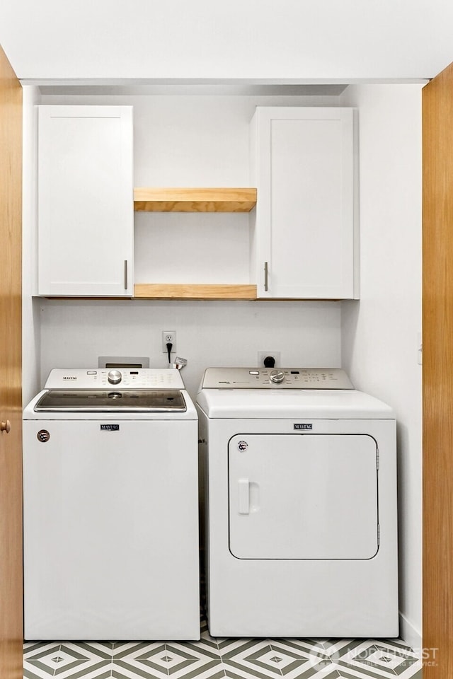 laundry area featuring cabinet space and separate washer and dryer