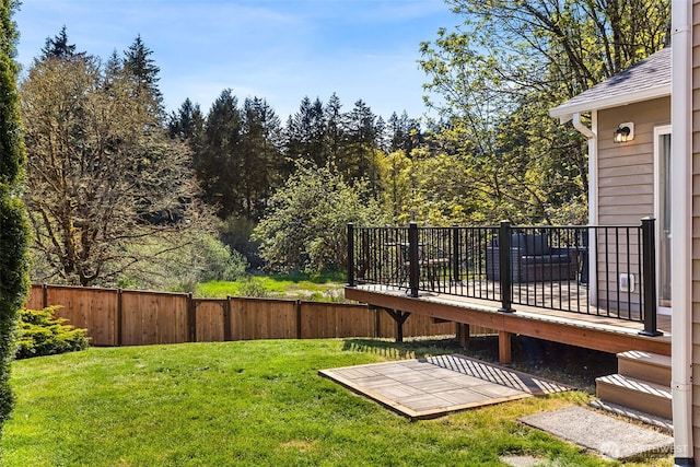 view of yard with a fenced backyard and a wooden deck