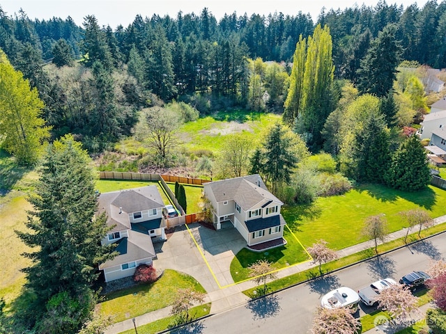aerial view featuring a residential view and a wooded view