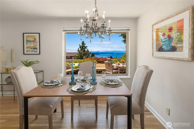 6743 40th Ave SW, Seattle, WA 98136 - dining area with a chandelier and wood finished floors